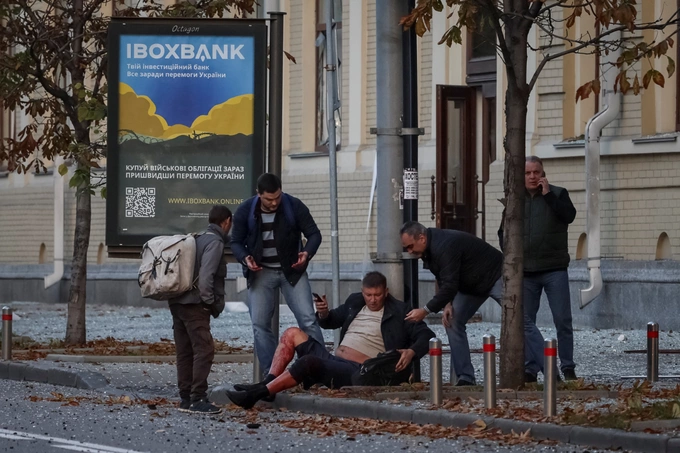 People attend a wounded man after Russian military strike, as Russias invasion of Ukraine continues, in central Kyiv, Ukraine October 10, 2022. Photo by Reuters/Gleb Garanich