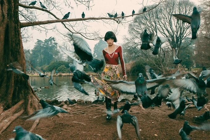 In addition to attending fashion house shows, Chau did several photo shoots in Milan. Here, she mixed a Gucci and Adidas sports top with a floral skirt and high boots while posing with pigeons by a river.