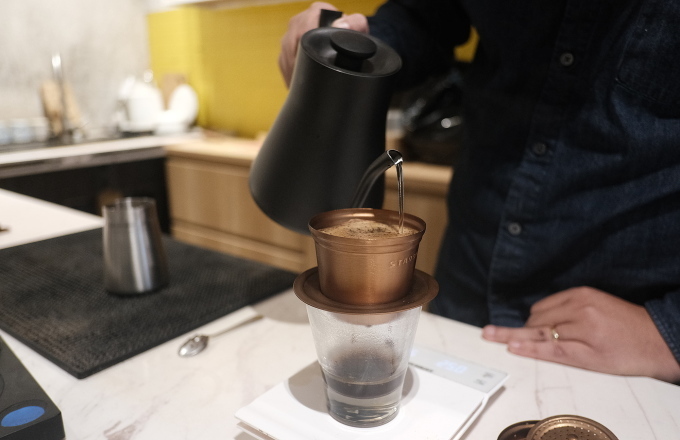 Pham Quoc Cuong makes coffee using a Vietnamese filter called a phin. Photo by Anh Tu