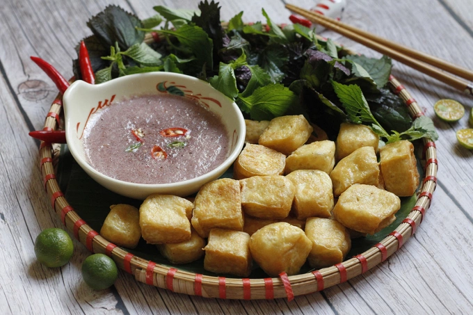 Golden fried tofu can taste even better when eaten with mam tom. Photo by VnExpress