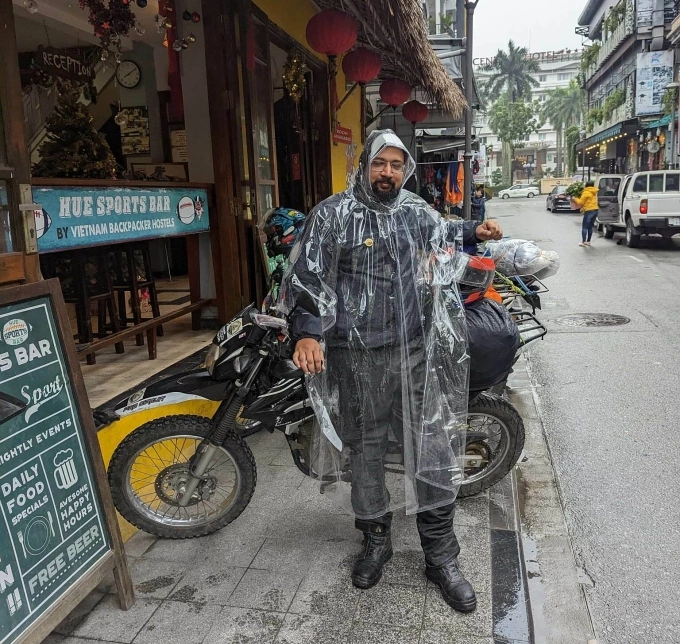 Pritesh Meta stands in front of a bar in Hue, central Vietnam, on a rainy day in February 2023. Photo courtesy of Pritesh Meta