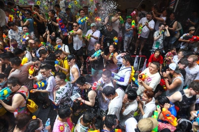 People play with water as they celebrate the Songkran holiday which marks the Thai New Year in Bangkok, Thailand, April 13, 2023. Photo by Reuters/Athit Perawongmetha
