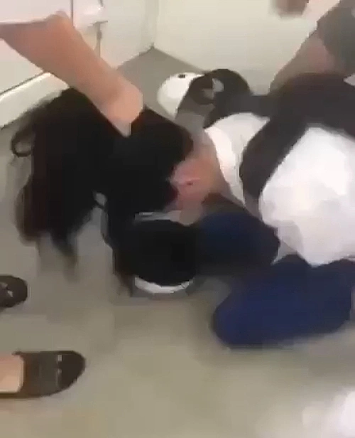 A still from an online video shows an eight-grade girl is beatean by other students in a restroom of Gio Linh Secondary School in Quang Tri Province in central Vietnam, April 24, 2023.