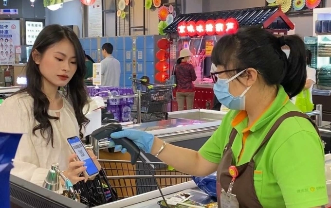Giang uses a QR code to pay at a supermarket in Beijing, China. Photo courtesy of Giang