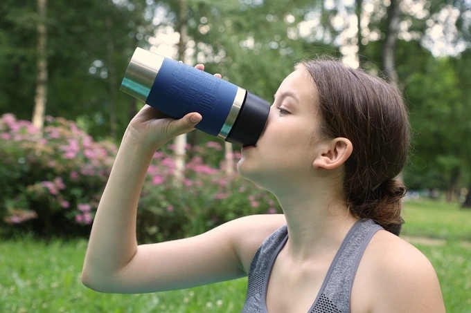 A girl drinking water. Illustration photo by Unsplash