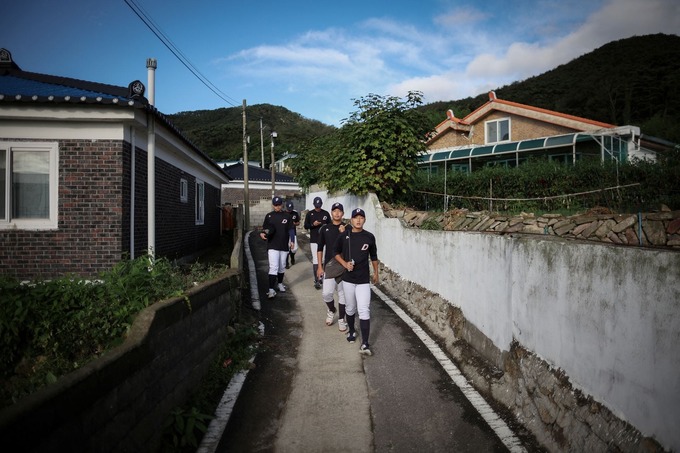 Members of the Deokjeok High School baseball team walk to school on Deokjeok island in Incheon, South Korea, September 14, 2023. Photo by Reuters/Kim Hong-Ji