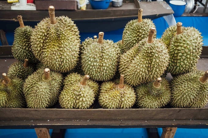Durians for sale at a market. Photo illustration by Freepik