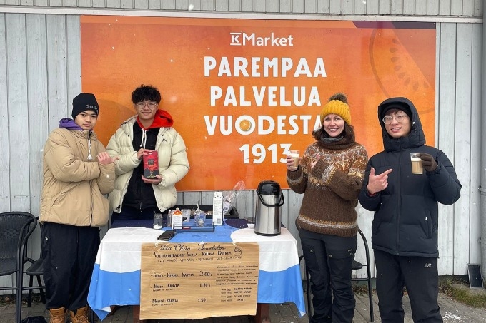 Na Uy, 17 years old (far right) with friends at his coffee counter. Photo courtesy of Na Uy