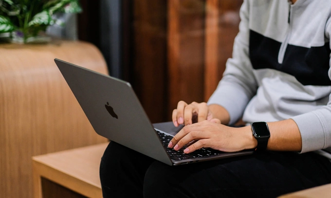 A man using a MacBook Air M2. Photo by Tuan Hung