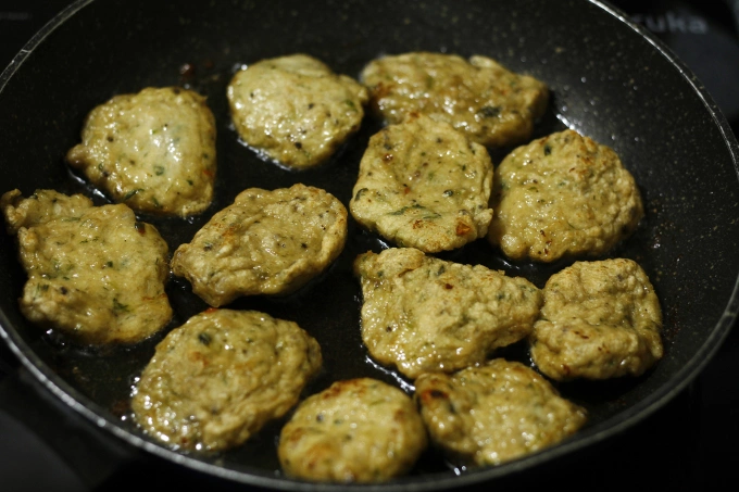 The fried fish cake has a firmer texture, highlighted by browned edges. Photo by VnExpress/Bui Thuy
