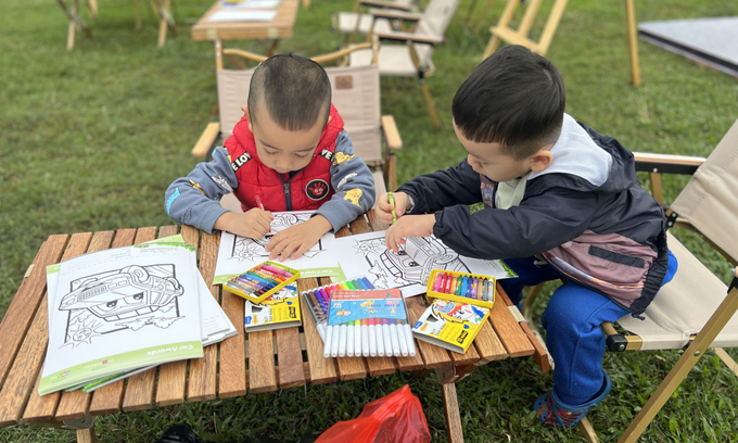 The children coloring pictures of cars. Photo by Minh Hy
