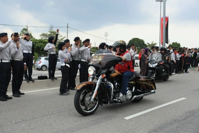 Sultan Ibrahim Iskandar rides a motorbike to meet with Johor residents in 2015. Photo from his Facebook page