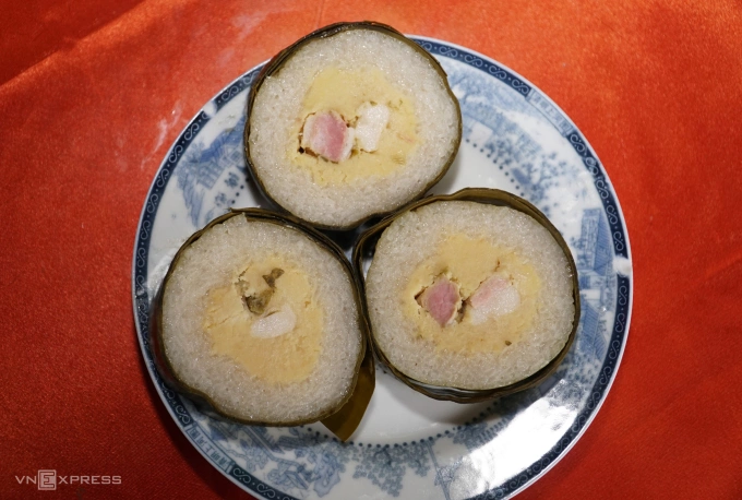 Having a similar filling to banh chung, banh tet is shaped in a cylindrical form, distinguishing it from its square counterpart. Photo by VnExpress/Truong Ha