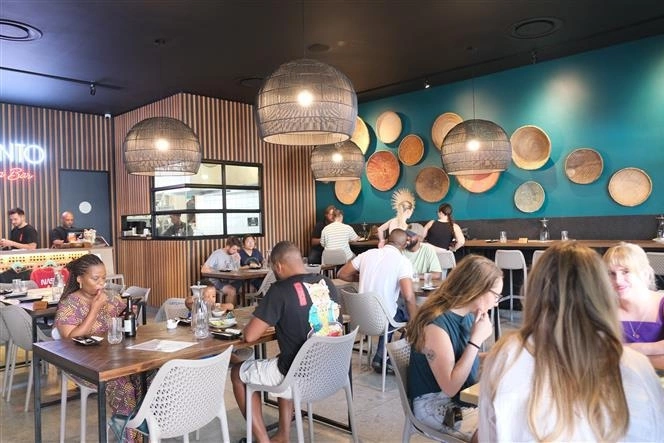 Diners enjoy Vietnamese cuisine at the restaurant. Photo by VNA.