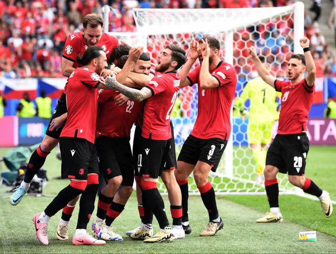 Georgias Georges Mikautadze (22) celebrates scoring their first goal with teammates. Photo by Reuters
