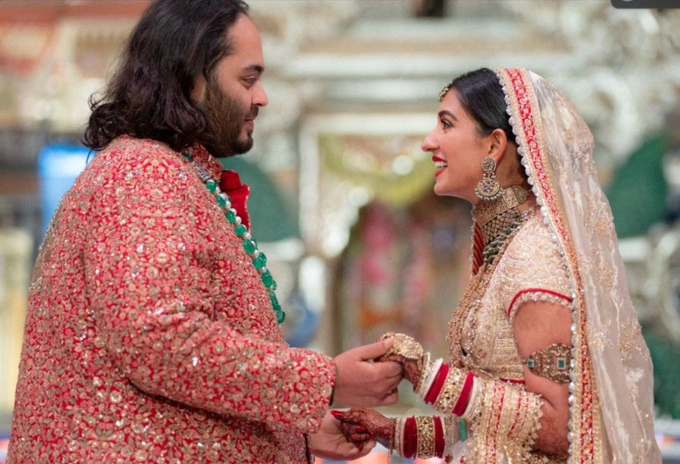 Anant Ambani, son of Indian billionaire Mukesh Ambani, and Radhika Merchant, daughter of industrialist Viren Merchant, react during their wedding celebrations in Mumbai, India, July 12, 2024. Photo by Reliance Industries via Reuters