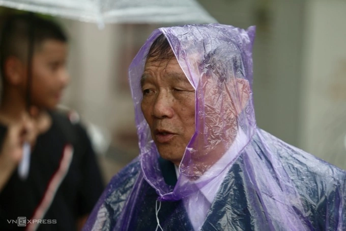 A man wears a raincoat near the National Funeral Home.