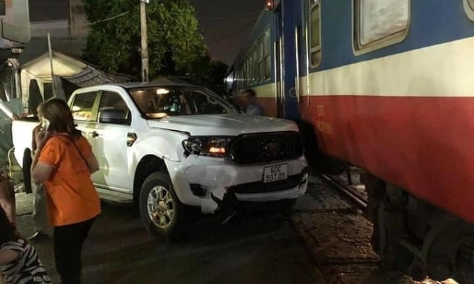In this photo provided by local people, a pickup truck collides with a train in Bien Hoa City, July 28, 2024.