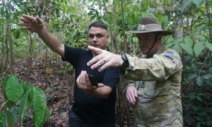 Luke Johnston (L) and Duncan Reid, Assistant Defense Attaché at the Australian Embassy in Vietnam during a search mission in a rubber forest of Binh Duong Province. Photo by Nguyen Xuan Thang