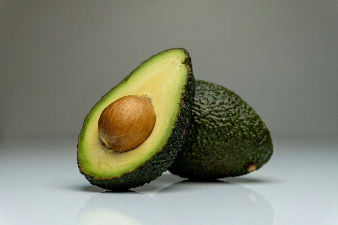 An avocado cut in half. Illustration photo by Unsplash
