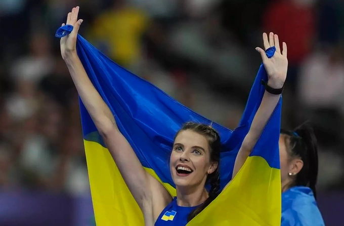 Yaroslava Mahuchikh wears the Ukraine flag after winning the womens high jump gold medal at the Paris Olympics on Aug. 4, 2024. Photo by AP