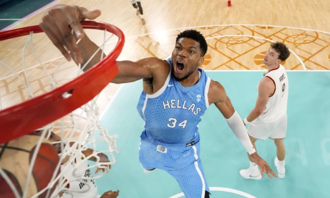 Giannis Antetokounmpo, center, of Greece, dunks as Johannes Thiemann, left, of Germany, and Franz Wagner, of Germany, defend during a men’s basketball game at the 2024 Summer Olympics, Tuesday, Aug. 6, 2024, in Paris, France. Photo by AP