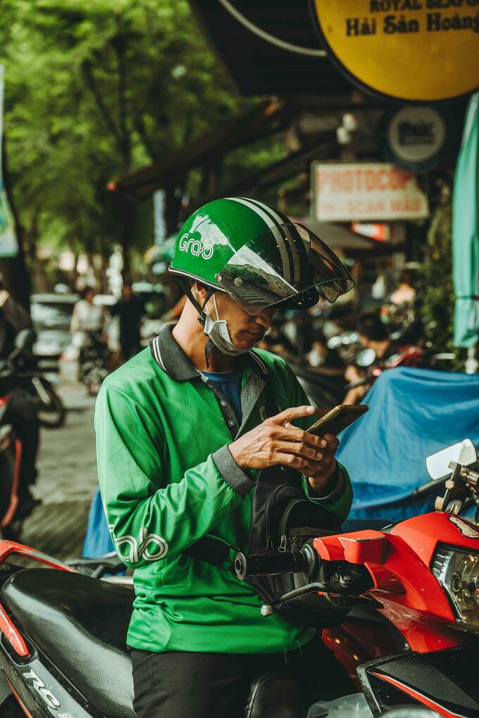 A Grab motorbike-taxi driver. Illustration from Pexels