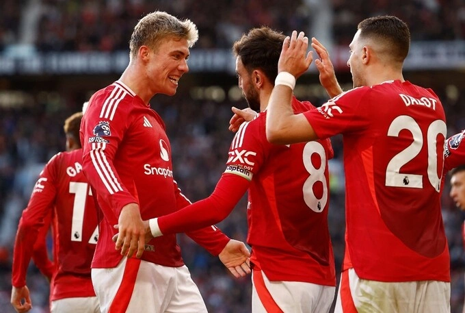 Manchester United players celebrate a goal during a Premier League match. Photo by Reuters