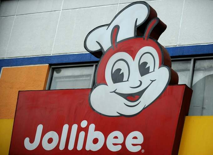 A picture shows a Jollibee logo in a street in Manila on June 22, 2011. Photo by AFP