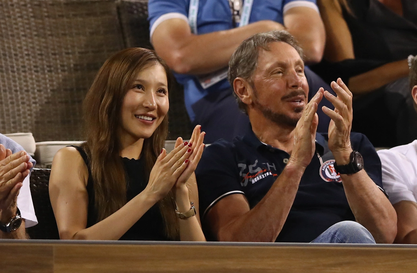 Billionaire Larry Ellison (R) and a woman identified as Jolin Zhu, his alleged fifth wife, watch Stanislas Wawrinka of Switzerland play against Dominic Thiem of Austria in their quarter final match during day eleven of the BNP Paribas Open at Indian Wells Tennis Garden on March 16, 2017 in Indian Wells, California. Photo handout via AFP