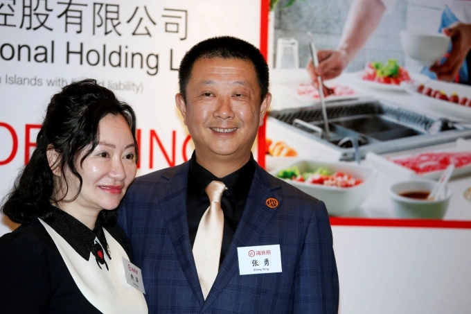 Zhang Yong (right) and his wife Shu Ping, co-founders of the hotpot chain Haidilao, pose before an investors luncheon ahead of the companys IPO in Hong Kong, China, on Sept. 10, 2018. Photo by Reuters