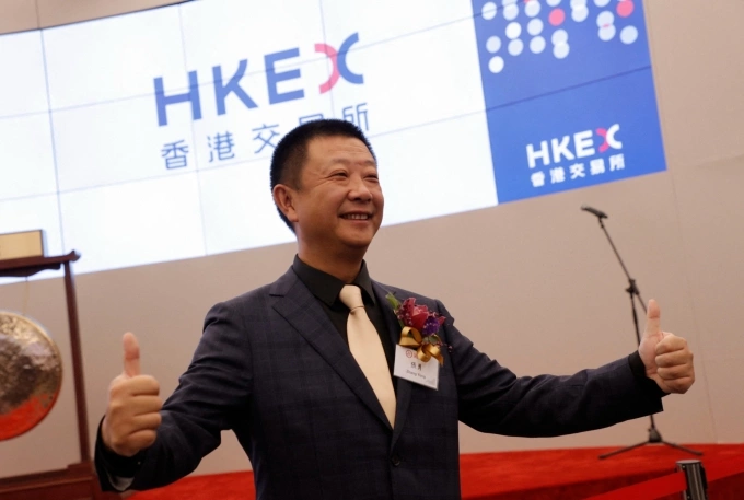 Zhang Yong, founder of Haidilao International Holding, poses during the ceremony for the listing of Chinese hotpot chain Haidilao at the Hong Kong Stock Exchange in Hong Kong, China, on Sept. 26, 2018. Photo by AFP