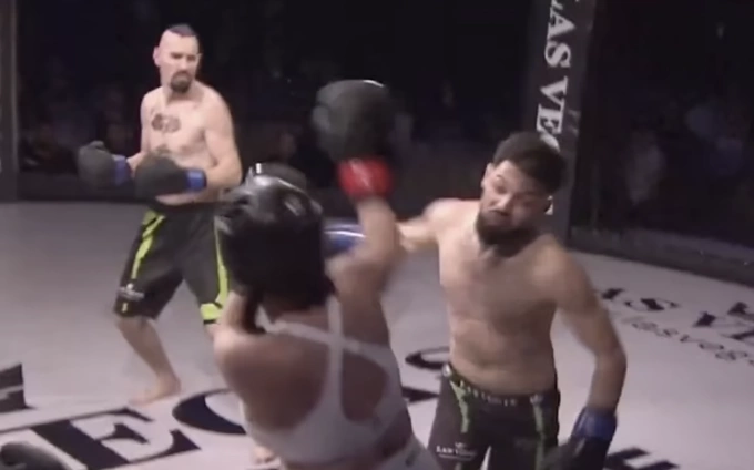 A screenshot of fighter Sebastian Rechinu swings his fist at a female influencer during an MMA match in Romania on Feb. 19, 2025