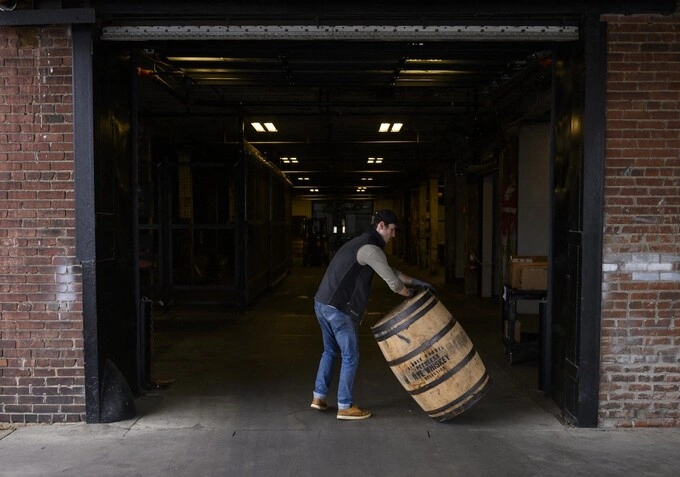 A person rolls a barrel for bourbon into the Kentucky Peerless Distilling company in Louisville, Kentucky on April 11, 2019. Photo by Reuters