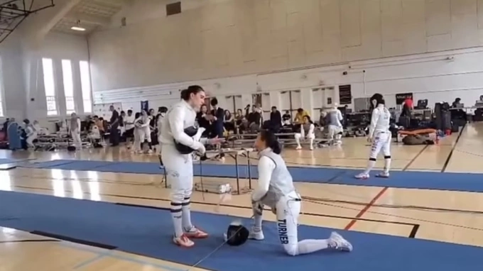 A screenshot of fencer Stephanie Turner kneeling and refusing to compete with transgender opponent Redmond Sullivan at the Cherry Blossom tournament on March 30, 2025