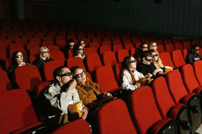 People sitting in a theater. Illustration photo by Pexels