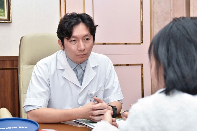 Dr Manh consults on treatment for a young patient with high blood pressure. Photo by VnExpress/Linh Dan