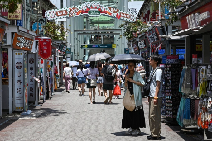 People walk along a pedestrian street in the Chinatown district of Singapore on October 7, 2024. Photo by AFP