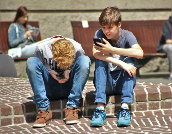 Teenage boys useing phones. Photo from Pexels