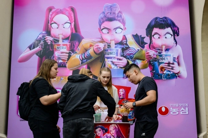 Visitors eat snacks near a ‘KPop Demon Hunters’ themed zone at the Everland Resort, South Koreas largest theme park, in Yongin, Gyeonggi Province on September 30, 2025. Photo by AFP