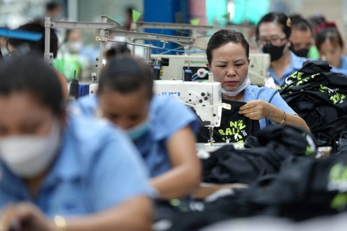 Vietnamese garment factory workers stitch apparel at a factory in Ho Chi Minh City on April 3, 2025. Photo by AFP