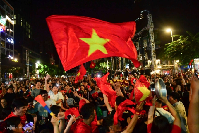 Los fanáticos estallan de celebración en una calle de la ciudad de Ho Chi Minh cuando el equipo vietnamita aseguró la victoria sobre Corea del Sur después de una tensa tanda de penales.