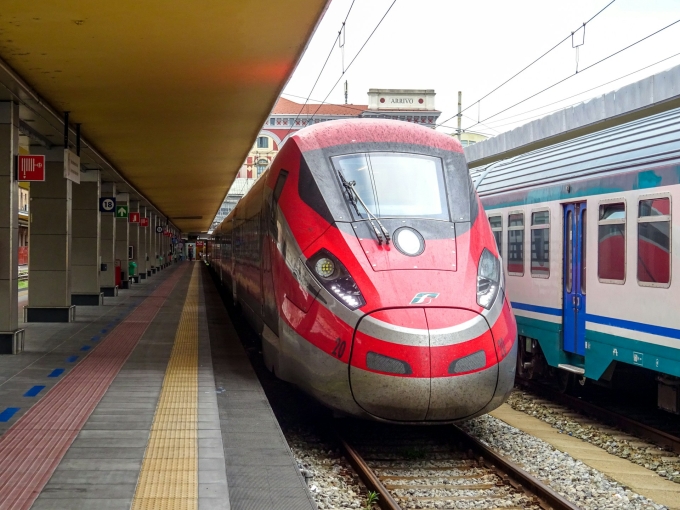 Two high-speed trains wait at the platform in a station in Beijing, China. Photo by Unsplash/Eric Prouzet