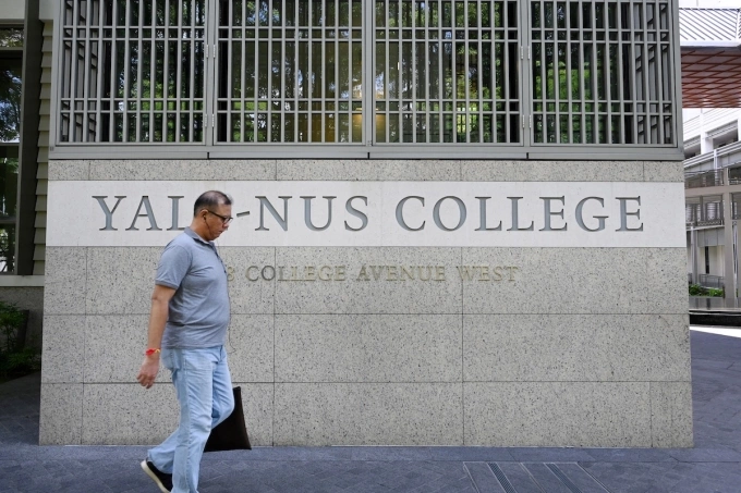 A man walks past signage for the Yale-NUS College in Singapore on October 14, 2019. Photo by AFP