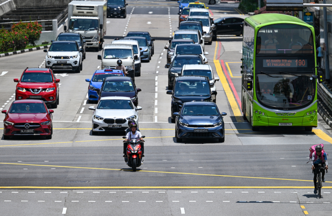 Vehicles drive at an intersection in the Chinatown district of Singapore on October 7, 2024. Photo by AFP