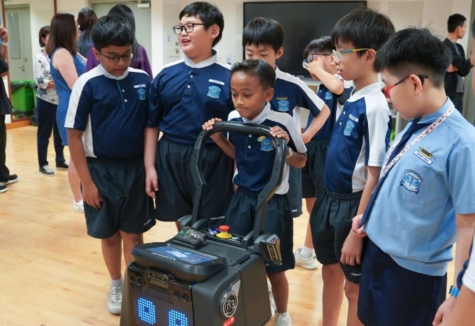 Students from a primary school at an event to introduce the program in March, 2025. Photo from the LionsBot Internationals Facebook page