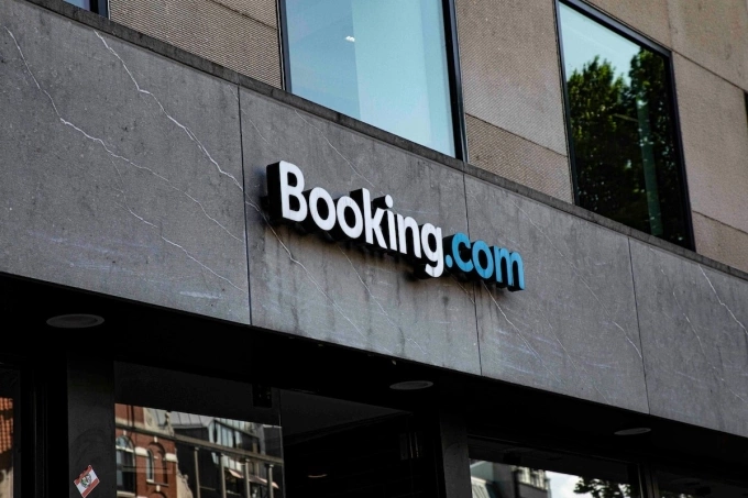 The logo of Booking.com is seen on a building in Amsterdam, the Netherlands. Photo by Unsplash/Jas Rolyn