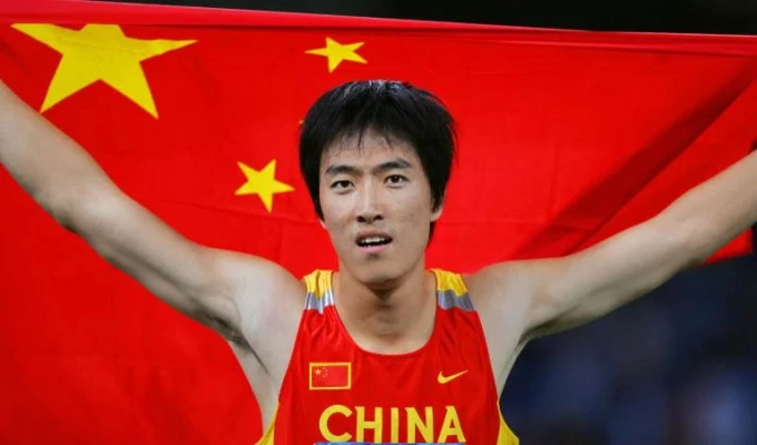 Chinas Liu Xiang celebrates after winning gold in the 110 m hurdles final at the Athens Olympics in August 2004. Photo by AFP