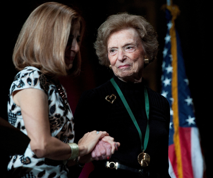 California first lady Anne Gust Brown (L) walks on the stage with Gap clothing store chain founder Doris Fisher after she was inducted along with her late husband Donald, during the 2011 California Hall of Fame Induction Ceremony in Sacramento, California, Dec. 8, 2011. Photo by Reuters