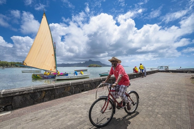 A person rides a bicycle in Grand Port district, Mauritius. Photo by Hemis via AFP